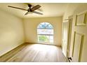 Bright bedroom featuring wood-look floors and an arched window at 3377 Fox Hunt Dr # B, Palm Harbor, FL 34683