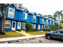 Blue townhouses with manicured lawns and parking spaces at 3377 Fox Hunt Dr # B, Palm Harbor, FL 34683