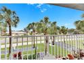 Balcony overlooking a residential street and palm trees at 4250 37Th S St # 5, St Petersburg, FL 33711