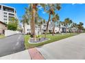 White condo building with landscaping and palm trees at 4250 37Th S St # 5, St Petersburg, FL 33711