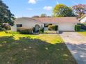 Bright exterior view of a single-story house with a large yard at 4345 Union Springs Rd, Spring Hill, FL 34608