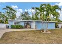 Cute light blue house with palm trees and a spacious yard at 5715 20Th W St, Bradenton, FL 34207