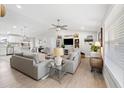 Open concept living space with gray sofas and a large TV at 6233 Florida E Cir, Apollo Beach, FL 33572