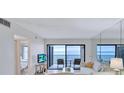 Bright living room featuring a large window with bay view and comfortable seating arrangement at 6322 Palma Del Mar S Blvd # 209, St Petersburg, FL 33715