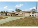 House exterior showcasing a spacious yard and attached garage at 6388 21St N Ave, St Petersburg, FL 33710