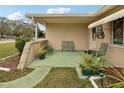 Relaxing front porch with metal seating and potted plants at 6388 21St N Ave, St Petersburg, FL 33710