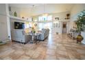Bright living room featuring vaulted ceilings and comfy seating at 6769 Greenview Ln, Englewood, FL 34224
