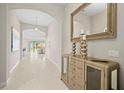 Bright entryway with tile floors and a decorative console table at 7401 Paradiso Dr, Apollo Beach, FL 33572