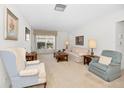 Bright and airy living room with comfortable seating and large window at 8236 Brentwood Rd, Seminole, FL 33777