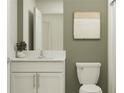 Modern bathroom with white vanity, quartz countertop, and green accent wall at 8416 Sea Ray Run, Parrish, FL 34219