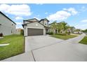 Two-story house with a two-car garage and a landscaped yard at 9512 Lemon Drop Loop, Ruskin, FL 33573