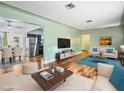 Bright living room with hardwood floors and view into kitchen at 9909 48Th N Ave, St Petersburg, FL 33708
