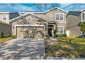 Two-story house with a two-car garage and landscaped lawn at 12509 Bay Branch Ct, Tampa, FL 33635