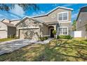 Two-story house with a two-car garage and landscaped lawn at 12509 Bay Branch Ct, Tampa, FL 33635