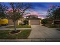 Two-story house with a two-car garage at dusk at 12610 Geneva Glade Dr, Riverview, FL 33578