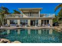 Inviting pool area with patio furniture and a view of the house at 1302 Belcher Dr, Tarpon Springs, FL 34689