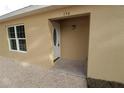 White front door with oval window and light fixture at 156 Grand Ave, Brooksville, FL 34604