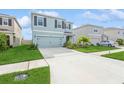 Two-story house with light blue exterior, two-car garage, and landscaped front yard at 17048 Oval Rum Dr, Wimauma, FL 33598