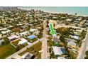 Aerial view showcasing a teal house's location near the beach amongst other houses at 214 85Th St, Holmes Beach, FL 34217