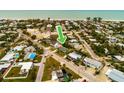 Aerial view of a teal house near the beach, surrounded by other homes and lush greenery at 214 85Th St, Holmes Beach, FL 34217