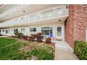 Front entrance of building with landscaping and seating area at 2363 Israeli Dr # 25, Clearwater, FL 33763