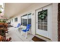 Condo unit entryway with two chairs and a wreath at 2363 Israeli Dr # 25, Clearwater, FL 33763