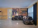 Spacious living room with a mural, sectional sofa, and marble floors at 263 Overbrook E St, Largo, FL 33770