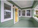 Inviting front porch with yellow door and light fixtures at 2758 3Rd S Ave, St Petersburg, FL 33712