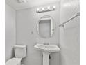 Simple bathroom with pedestal sink and a round mirror at 314 Barlow Ave # 73, Sarasota, FL 34232