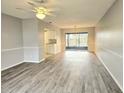 Spacious living room with wood-look floors and access to a patio at 314 Barlow Ave # 73, Sarasota, FL 34232