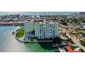 Condo complex with lush landscaping, community pool, and boat docks at 400 64Th Ave # 502, St Pete Beach, FL 33706