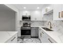 Modern white kitchen with marble counters and gold accents at 400 64Th Ave # 502, St Pete Beach, FL 33706