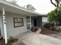 Front entrance with a covered porch and walkway at 4108 W Oakellar Ave, Tampa, FL 33611