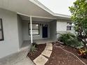 Updated front entryway with a covered porch and landscaping at 4108 W Oakellar Ave, Tampa, FL 33611