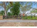 Red house with a black fence, landscaping, and a paved walkway at 4334 3Rd N Ave, St Petersburg, FL 33713