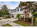 Tan townhome with attached garage and mature landscaping at 4533 Ashburn Square Dr # 4533, Tampa, FL 33610