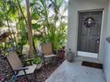 Inviting front patio with seating and tropical landscaping at 5890 38Th N Ave # 101, St Petersburg, FL 33710