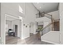 Bright foyer features soaring ceilings and a beautiful staircase to the second floor at 6307 Brevada Ln, Apollo Beach, FL 33572