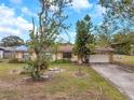 One-story home with a tree-lined yard and attached garage at 6327 5Th Street E Cir, Bradenton, FL 34203