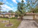 House exterior showcasing a driveway and mature trees at 6327 5Th Street E Cir, Bradenton, FL 34203