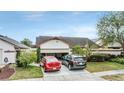 House exterior featuring a two-car garage and landscaping at 6931 Silvermill Dr, Tampa, FL 33635