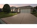 Brick house with a two-car garage at dusk at 7473 Willow Brook Dr, Spring Hill, FL 34606