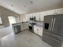 Modern kitchen with stainless steel appliances and marble countertops at 7533 Merchantville Cir, Zephyrhills, FL 33540