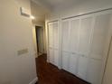 Hallway with two large white closets and wood flooring at 7724 St Andrews Blvd, Weeki Wachee, FL 34613