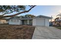 Newly painted light blue ranch home with a spacious driveway at 7930 Valmy Ln, Port Richey, FL 34668