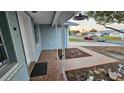 Newly tiled entryway with a charming walkway leading to the front door at 7930 Valmy Ln, Port Richey, FL 34668