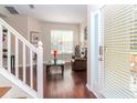 Living room with hardwood floors, a staircase, and a view to the backyard at 8811 Casablanca Way # 106, Tampa, FL 33626