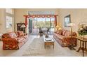 Spacious living room with pool view and floral sofas at 9144 Highland Ridge Way, Tampa, FL 33647