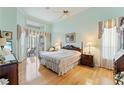 Bright main bedroom with wood floors and access to patio at 9144 Highland Ridge Way, Tampa, FL 33647