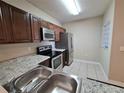 Modern kitchen with stainless steel appliances and granite countertops at 9521 Grovedale Cir # 201, Riverview, FL 33578